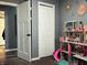 Bedroom view with closet door, an additional doorway, and a dollhouse with carpeted floors at 109 S County Line Rd, , IN 47272