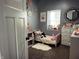Charming bedroom featuring a twin bed, a large window and a white dresser at 109 S County Line Rd, , IN 47272