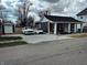 A cute single-story house with a front porch, side parking, and a well-maintained yard at 109 S County Line Rd, , IN 47272