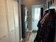Functional laundry area featuring stacked washer/dryer, cabinet, and back door at 109 S County Line Rd, , IN 47272