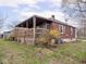 Exterior view of the backyard with a covered porch and brick house siding at 1237 E Pleasant Run Pkwy S Dr, Indianapolis, IN 46203