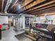 Unfinished basement with exposed ceiling, concrete floor, seating area, and laundry appliances at 1237 E Pleasant Run Pkwy S Dr, Indianapolis, IN 46203
