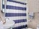 Bathroom with classic tile, sink, and striped shower curtain at 1237 E Pleasant Run Pkwy S Dr, Indianapolis, IN 46203