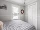 Bright bedroom with large window, decorative wall art, and patterned quilt at 1237 E Pleasant Run Pkwy S Dr, Indianapolis, IN 46203