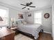 Cozy bedroom with ceiling fan, decorative wall art, and natural light at 1237 E Pleasant Run Pkwy S Dr, Indianapolis, IN 46203