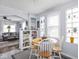 Eat-in kitchen and open-concept living room with hardwood floors and ample natural light at 1237 E Pleasant Run Pkwy S Dr, Indianapolis, IN 46203