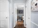 Hallway with two closets and a view into a neutral bedroom at 1237 E Pleasant Run Pkwy S Dr, Indianapolis, IN 46203