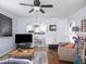 Cozy living room with hardwood floors, ceiling fan and an open archway leading to the kitchen at 1237 E Pleasant Run Pkwy S Dr, Indianapolis, IN 46203