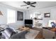 Cozy living room with hardwood floors, ceiling fan and an open archway leading to the kitchen at 1237 E Pleasant Run Pkwy S Dr, Indianapolis, IN 46203