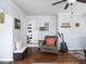 Cozy living room features wood floors, wainscoting, and eclectic decor at 1237 E Pleasant Run Pkwy S Dr, Indianapolis, IN 46203
