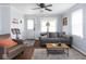 A comfortable living room featuring a gray sofa, wood floors and a decorative front door at 1237 E Pleasant Run Pkwy S Dr, Indianapolis, IN 46203