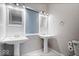 Well-lit bathroom with dual sinks, decorative mirrors, and a modern design at 1310 N Chester Ave, Indianapolis, IN 46201