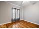 Cozy bedroom showcasing hardwood floors, a large window with natural light, and neutral walls at 1310 N Chester Ave, Indianapolis, IN 46201