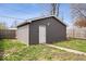 Garage with a door, surrounded by grass, and a wooden fence, offering outdoor storage at 1310 N Chester Ave, Indianapolis, IN 46201