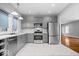 Contemporary kitchen with stainless steel appliances, grey cabinets, and eat in area at 1310 N Chester Ave, Indianapolis, IN 46201