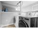 Well-lit laundry room with side-by-side washer and dryer on a tile floor at 1310 N Chester Ave, Indianapolis, IN 46201