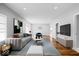 Bright living room featuring hardwood floors, modern furnishings, and an open floor plan at 1310 N Chester Ave, Indianapolis, IN 46201