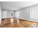 Spacious living room showcasing hardwood floors, ample natural light, and neutral paint at 1310 N Chester Ave, Indianapolis, IN 46201