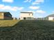 Large backyard with a well-maintained lawn and a view of the two-story home at 13211 N Landing W Cir, Camby, IN 46113