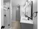 Modern bathroom featuring double sinks, gray cabinets, and a walk-in shower with glass doors at 13211 N Landing W Cir, Camby, IN 46113