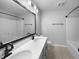 Well-lit bathroom featuring double sinks, modern fixtures, and a shower-tub combination with sleek black accents at 13211 N Landing W Cir, Camby, IN 46113