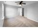 A bright bedroom featuring neutral walls, a ceiling fan, and an open doorway to a closet or ensuite at 13211 N Landing W Cir, Camby, IN 46113