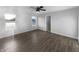 Bright bedroom with hardwood flooring features a ceiling fan and natural light from two windows at 13211 N Landing W Cir, Camby, IN 46113