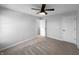 Carpeted bedroom includes ceiling fan, natural light, and door leading to an additional room at 13211 N Landing W Cir, Camby, IN 46113