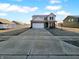 Two-story home with a concrete driveway, attached garage, and well-manicured lawn at 13211 N Landing W Cir, Camby, IN 46113