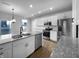 Modern kitchen features stainless steel appliances, granite countertops, and a central island with sink at 13211 N Landing W Cir, Camby, IN 46113