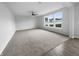 A spacious living room offers plush carpeting, neutral walls, and multiple windows for natural light at 13211 N Landing W Cir, Camby, IN 46113