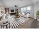 Bright living room features neutral decor, stylish furniture, and natural light from the large windows at 13211 N Landing W Cir, Camby, IN 46113