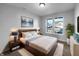 Cozy bedroom with a large bed, stylish lamps, wall art, and dual windows with natural light at 13211 N Landing W Cir, Camby, IN 46113