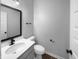 Stylish powder room showcases a sleek black mirror, modern fixtures, and a clean, minimalist design at 13211 N Landing W Cir, Camby, IN 46113