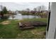 Scenic view of the backyard featuring a pond with fountain and mulched area, ideal for gardening at 143 Tracy Ridge Blvd, Whiteland, IN 46184