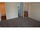 Carpeted bedroom featuring neutral walls and two open doorways to other rooms at 143 Tracy Ridge Blvd, Whiteland, IN 46184