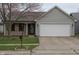 Charming single-story home featuring a well-maintained lawn and a two-car garage at 143 Tracy Ridge Blvd, Whiteland, IN 46184