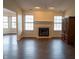 Bright living room with hardwood floors, a fireplace, and large windows offering ample natural light at 143 Tracy Ridge Blvd, Whiteland, IN 46184