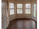 Bright sunroom featuring large windows that overlook the backyard pond with access to outdoor patio at 143 Tracy Ridge Blvd, Whiteland, IN 46184