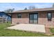 Brick house with a patio, lawn, and sliding glass door in the backyard at 153 Terrace Ct, Franklin, IN 46131