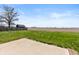 Spacious backyard with lush green grass and a barn in the distance, offering privacy at 153 Terrace Ct, Franklin, IN 46131