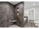 Bathroom showcases a tiled shower, corner seat, niche, and a view to the soaking tub and walk-in closet at 153 Terrace Ct, Franklin, IN 46131
