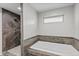 Modern bathroom featuring a shower with wood-look tile and a separate soaking tub at 153 Terrace Ct, Franklin, IN 46131
