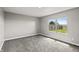 Neutral bedroom features gray walls, plush carpet, and a window overlooking the backyard at 153 Terrace Ct, Franklin, IN 46131