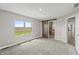 Bedroom features gray carpet, a barn door to the bathroom, and a window overlooking the fields at 153 Terrace Ct, Franklin, IN 46131
