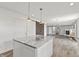 View of the kitchen island with granite countertops and a view to the living room with fireplace and slider door at 153 Terrace Ct, Franklin, IN 46131