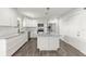 Modern white kitchen features granite countertops, stainless steel appliances, and center island with pendant lighting at 153 Terrace Ct, Franklin, IN 46131