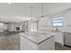 Open-concept kitchen with center island, granite countertops, and a view to the adjacent living room with fireplace at 153 Terrace Ct, Franklin, IN 46131
