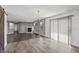 Living room features a modern chandelier, fireplace, gray walls, wood-look floors, and large sliding glass door at 153 Terrace Ct, Franklin, IN 46131