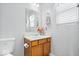Small bathroom featuring wood cabinets, mirror and window at 15444 Old Pond Cir, Noblesville, IN 46060